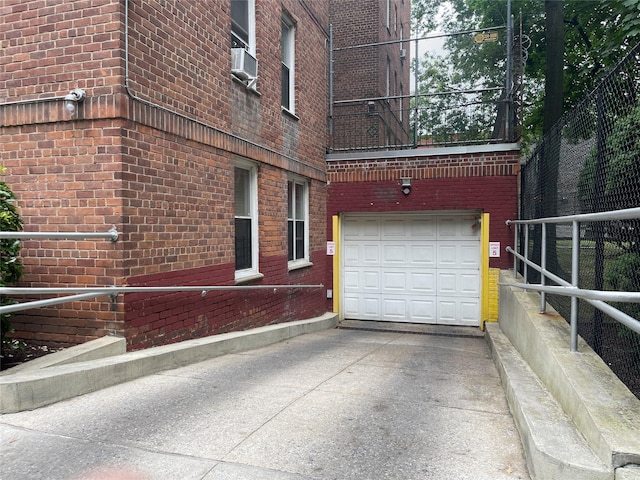 1480 Thieriot Ave Unit 6O, Bronx, NY 10460 - view of home's exterior featuring a garage, concrete driveway, brick siding, and cooling unit