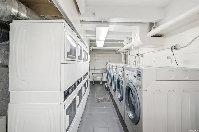 1480 Thieriot Ave Unit 6O, Bronx, NY 10460 - communal laundry room with stacked washer / drying machine, washer and dryer, and dark tile patterned flooring