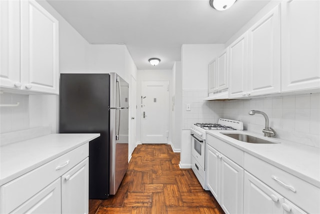 5355 Henry Hudson Pkwy W Unit 4G, Bronx, NY 10471 - kitchen featuring white range with gas stovetop, freestanding refrigerator, under cabinet range hood, a sink, and white cabinets