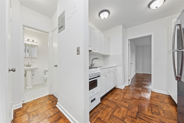 5355 Henry Hudson Pkwy W Unit 4G, Bronx, NY 10471 - kitchen with gas range gas stove, white cabinets, light countertops, and freestanding refrigerator