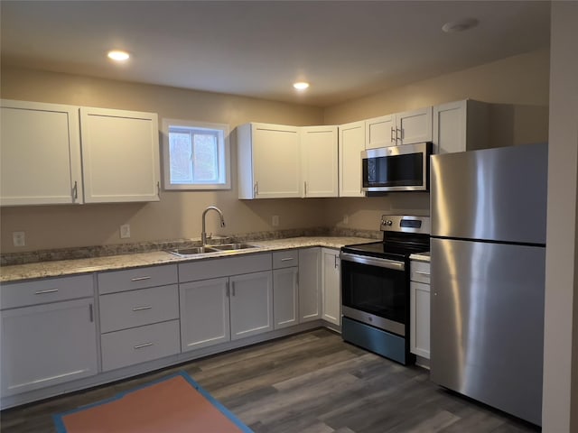 107 Pinewood Rd, Cochecton, NY 12726 - kitchen with appliances with stainless steel finishes, a sink, dark wood-style flooring, white cabinets, and recessed lighting