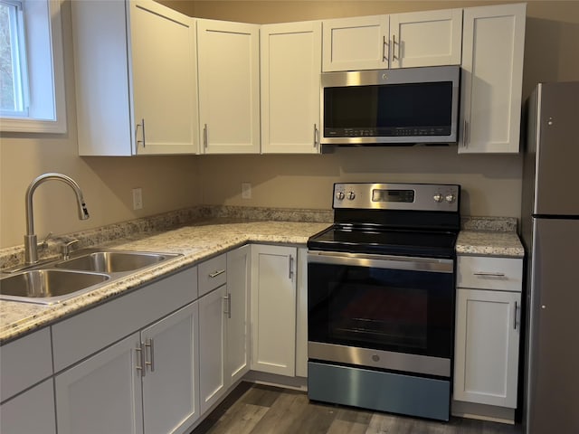 107 Pinewood Rd, Cochecton, NY 12726 - kitchen with stainless steel appliances, a sink, light countertops, and white cabinets