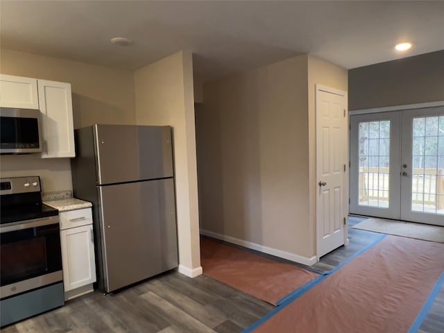 107 Pinewood Rd, Cochecton, NY 12726 - kitchen with appliances with stainless steel finishes, white cabinets, french doors, and dark wood-style flooring
