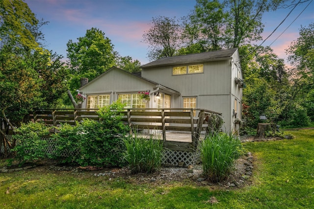 3300 Baker St Unit 20, Mohegan Lake, NY 10547 - back of house at dusk featuring a wooden deck and a lawn