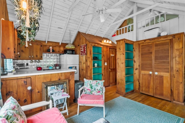 3300 Baker St Unit 20, Mohegan Lake, NY 10547 - kitchen with freestanding refrigerator, ceiling fan, wood walls, wood finished floors, and brown cabinets