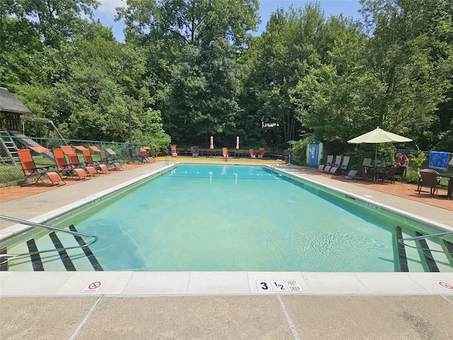 3300 Baker St Unit 20, Mohegan Lake, NY 10547 - community pool with view of wooded area and a patio area