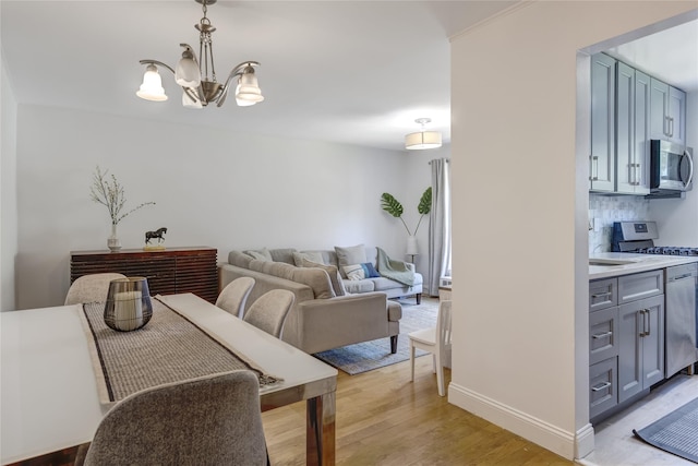221 Middle Neck Rd Unit M-4, Great Neck, NY 11021 - dining space with a chandelier and light wood finished floors