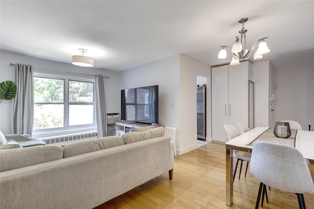 221 Middle Neck Rd Unit M-4, Great Neck, NY 11021 - living area with radiator heating unit, a chandelier, and light wood-style floors