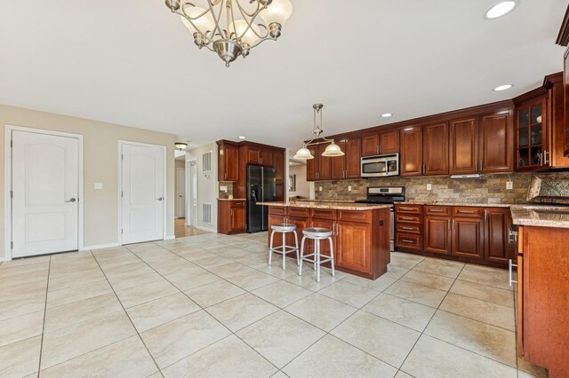 287 Atlantic Ave, Massapequa Park, NY 11762 - kitchen featuring appliances with stainless steel finishes, tasteful backsplash, a center island, light tile patterned floors, and recessed lighting