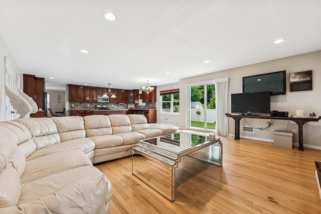 287 Atlantic Ave, Massapequa Park, NY 11762 - living room with light wood-style floors, a chandelier, and recessed lighting