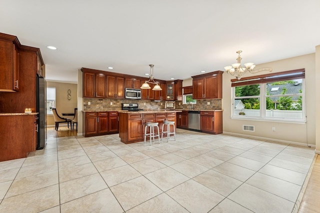 287 Atlantic Ave, Massapequa Park, NY 11762 - kitchen with stainless steel appliances, decorative backsplash, a chandelier, plenty of natural light, and recessed lighting