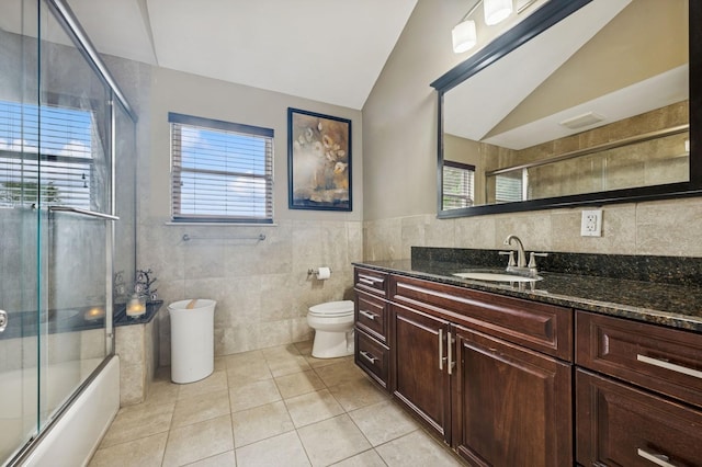 287 Atlantic Ave, Massapequa Park, NY 11762 - bathroom with tile walls, vanity, vaulted ceiling, tile patterned flooring, and plenty of natural light