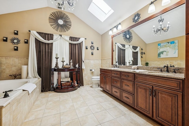 287 Atlantic Ave, Massapequa Park, NY 11762 - full bath with a skylight, tile walls, a bath, double vanity, and wainscoting