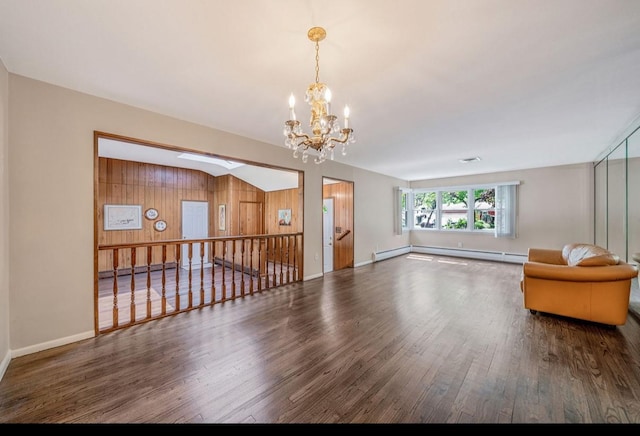 1 Leeward Ln, Commack, NY 11725 - unfurnished living room with a chandelier, wood finished floors, a baseboard heating unit, and wood walls