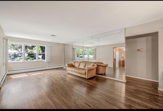 1 Leeward Ln, Commack, NY 11725 - living room with a baseboard heating unit and wood finished floors