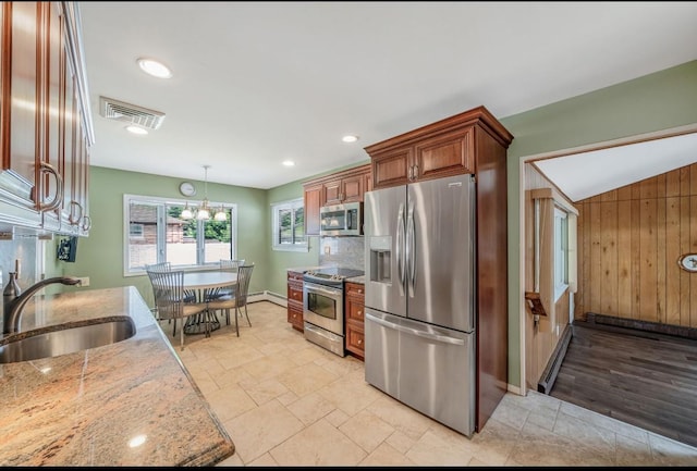 1 Leeward Ln, Commack, NY 11725 - kitchen with appliances with stainless steel finishes, light stone countertops, a chandelier, hanging light fixtures, and stone tile floors