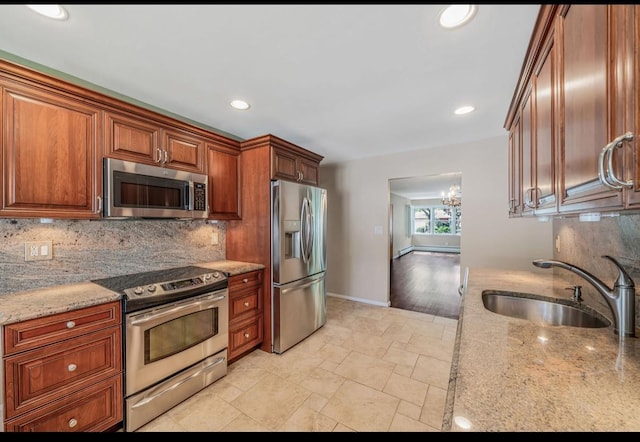 1 Leeward Ln, Commack, NY 11725 - kitchen with stainless steel appliances, tasteful backsplash, a chandelier, light stone counters, and recessed lighting