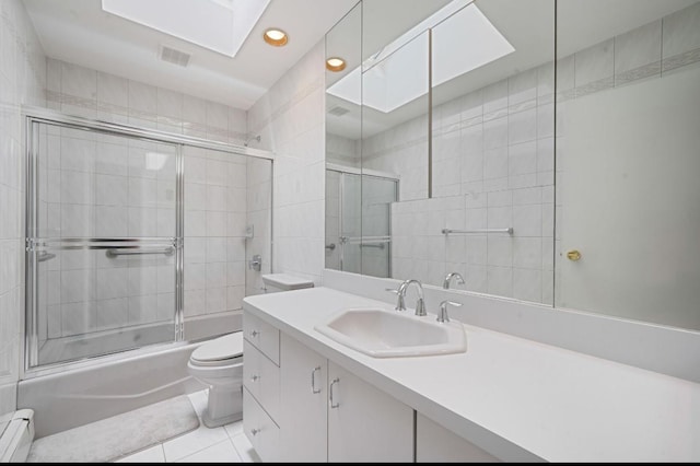1 Leeward Ln, Commack, NY 11725 - bathroom with a baseboard heating unit, vanity, combined bath / shower with glass door, recessed lighting, and tile patterned floors
