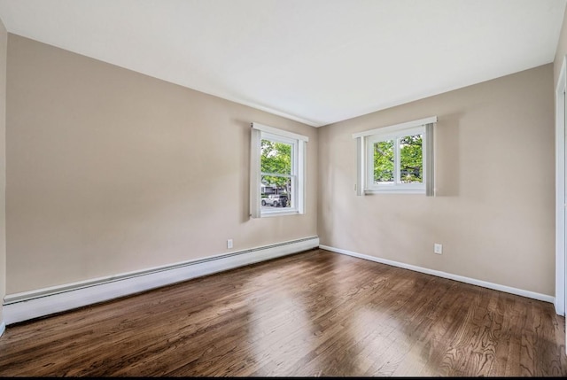 1 Leeward Ln, Commack, NY 11725 - empty room with a baseboard heating unit and wood finished floors