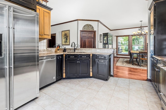204 Moore Rd, Germantown, NY 12526 - kitchen featuring appliances with stainless steel finishes, a sink, a chandelier, a peninsula, and ornamental molding