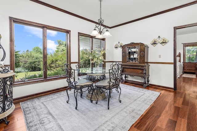 204 Moore Rd, Germantown, NY 12526 - dining area featuring crown molding, baseboards, wood finished floors, and a chandelier