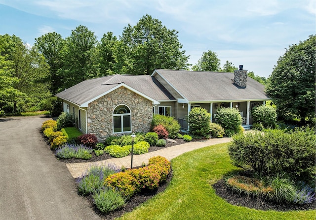204 Moore Rd, Germantown, NY 12526 - view of front of house with stone siding, a chimney, a front lawn, and an attached garage