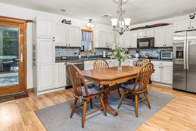 204 Moore Rd, Germantown, NY 12526 - dining space with a chandelier, light wood-style flooring, and plenty of natural light