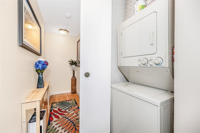 608 Kemeys Cv Unit 6-08, Briarcliff Manor, NY 10562 - laundry room with stacked washer / dryer, light wood-type flooring, and baseboards