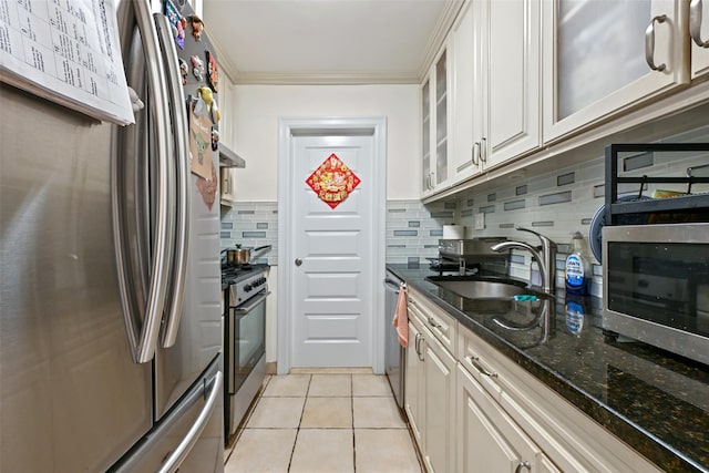 86-04 Grand Ave Unit 4D, Elmhurst, NY 11373 - kitchen featuring appliances with stainless steel finishes, a sink, backsplash, glass insert cabinets, and under cabinet range hood