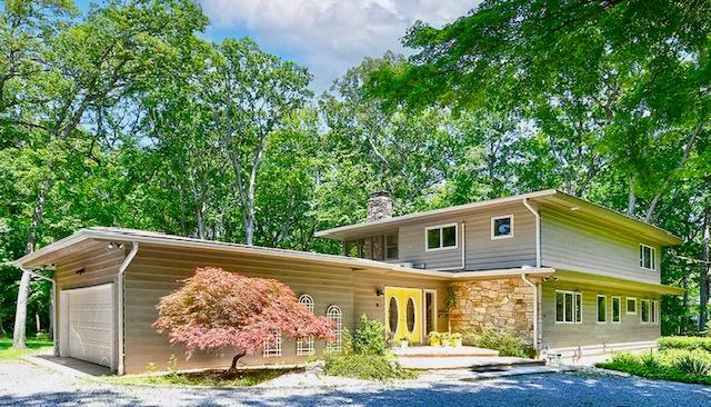 2 Wooded Ct, Lloyd Harbor, NY 11743 - view of front of property featuring a chimney, stone siding, a garage, and driveway