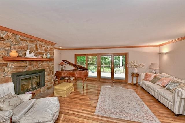 2 Wooded Ct, Lloyd Harbor, NY 11743 - living area with crown molding, wood finished floors, and a stone fireplace