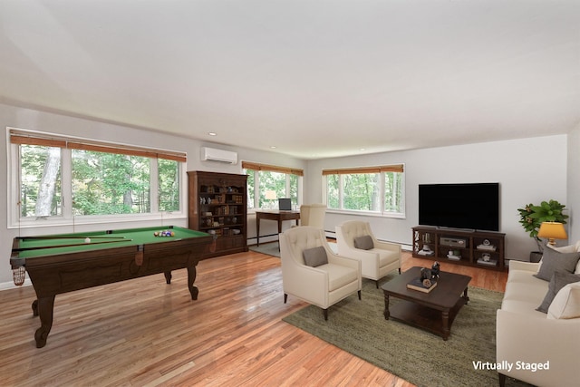 2 Wooded Ct, Lloyd Harbor, NY 11743 - living room featuring an AC wall unit, pool table, a baseboard radiator, light wood-style floors, and recessed lighting