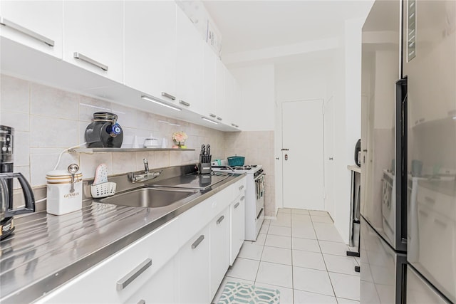 2 Fordham Hill Oval Unit 2F, Bronx, NY 10468 - kitchen featuring stainless steel countertops, white range with gas stovetop, light tile patterned floors, and white cabinetry