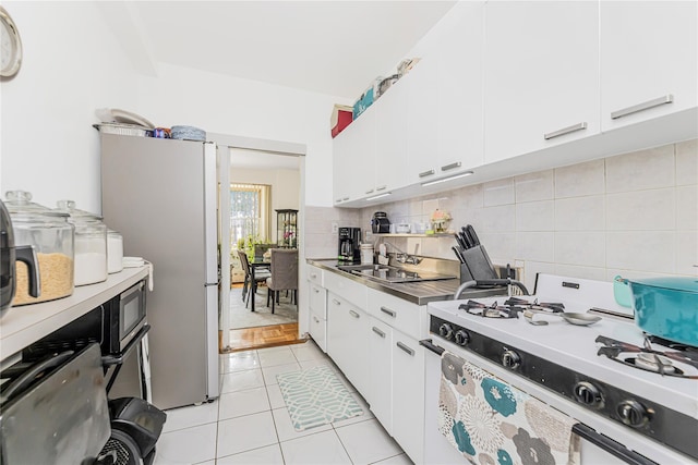 2 Fordham Hill Oval Unit 2F, Bronx, NY 10468 - kitchen with white appliances, backsplash, white cabinetry, and light tile patterned floors