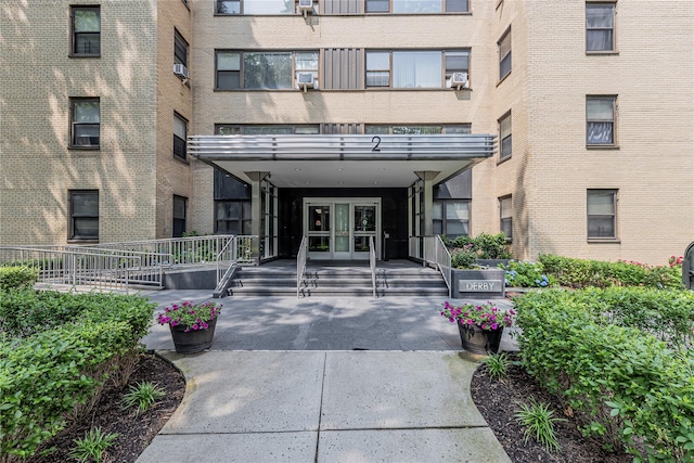 2 Fordham Hill Oval Unit 2F, Bronx, NY 10468 - doorway to property featuring french doors, brick siding, and cooling unit