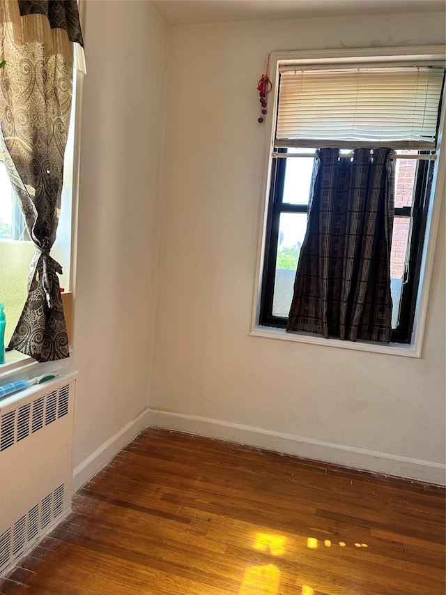 150-11 72nd Rd Unit 6A, Flushing, NY 11367 - unfurnished room featuring radiator, wood finished floors, and baseboards