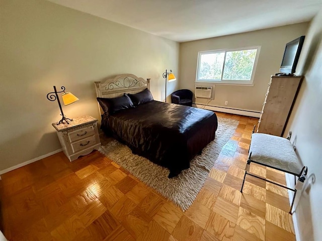 73 Adams Rd Unit 2B, Central Islip, NY 11722 - bedroom featuring baseboard heating, a wall unit AC, and baseboards