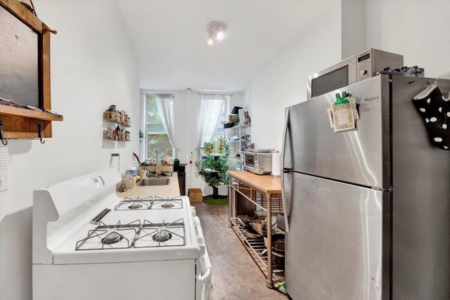 616 E 9th St Unit 2W, New York Manhattan, NY 10009 - kitchen with freestanding refrigerator, gas range gas stove, and a sink