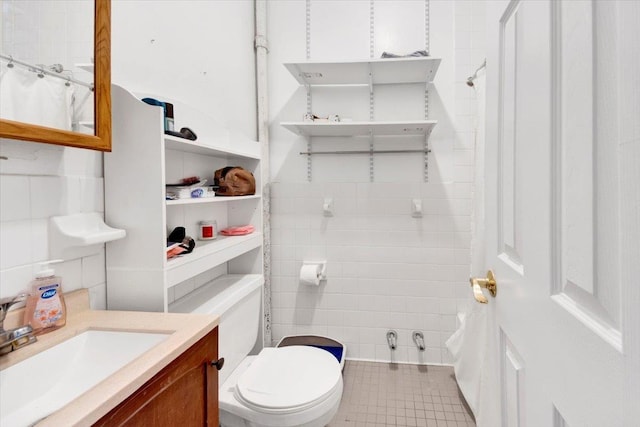616 E 9th St Unit 2W, New York Manhattan, NY 10009 - bathroom featuring vanity, toilet, tile patterned floors, tile walls, and a shower with curtain