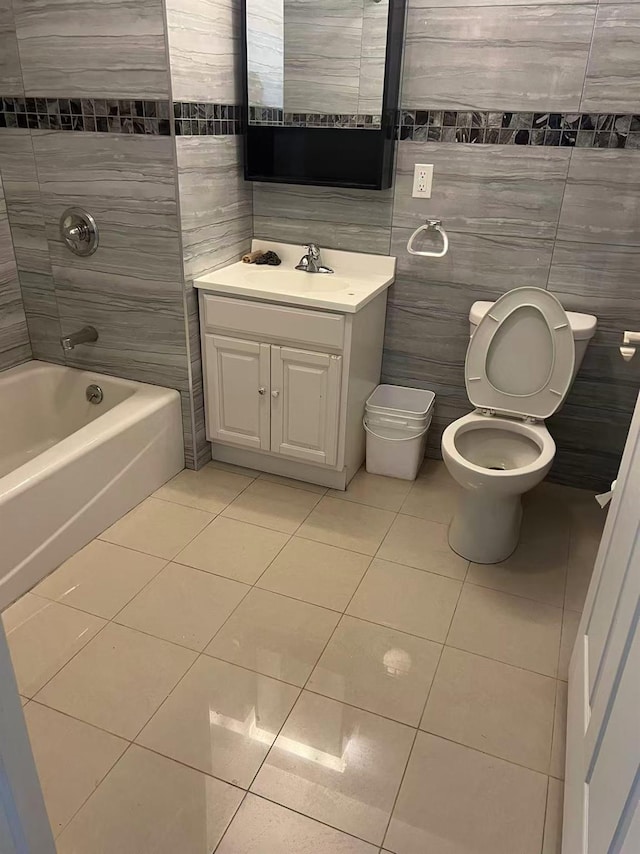 31-53 Linden Pl Unit 2E, Flushing, NY 11354 - bathroom featuring tile patterned floors, toilet, vanity, tile walls, and shower / washtub combination