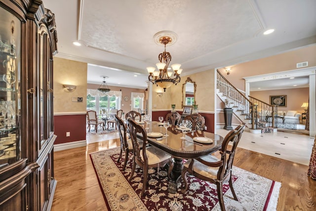 13 Locust Ln, Upper Brookville, NY 11545 - dining area featuring a raised ceiling, ornamental molding, a chandelier, light wood-type flooring, and recessed lighting