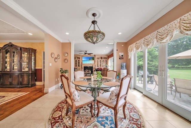 13 Locust Ln, Upper Brookville, NY 11545 - dining area with light tile patterned floors, a ceiling fan, a fireplace, recessed lighting, and crown molding