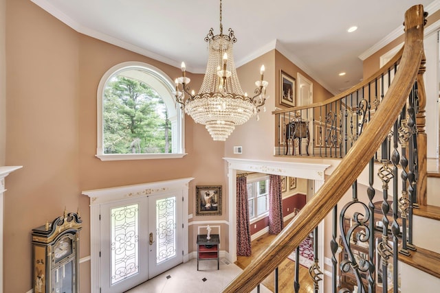 13 Locust Ln, Upper Brookville, NY 11545 - tiled foyer entrance with a chandelier, french doors, a towering ceiling, stairs, and ornamental molding