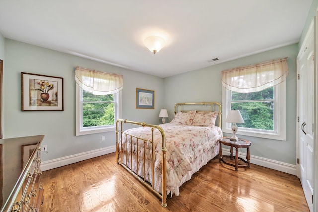 13 Locust Ln, Upper Brookville, NY 11545 - bedroom featuring multiple windows and light wood-style flooring