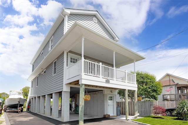 3717 Somerset Dr, Seaford, NY 11783 - view of front facade with a carport, a balcony, and driveway