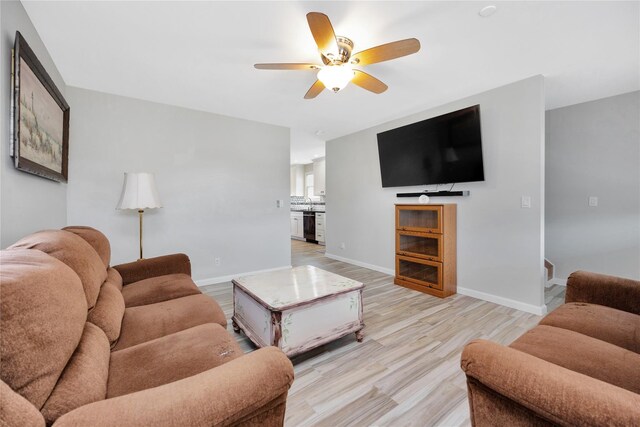 3717 Somerset Dr, Seaford, NY 11783 - living room with a ceiling fan, baseboards, and light wood-style floors