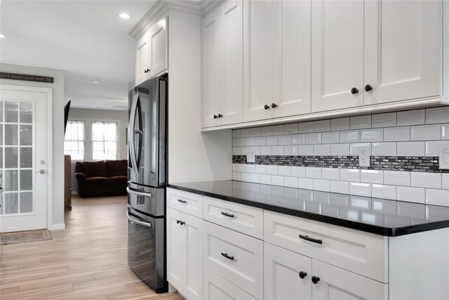3717 Somerset Dr, Seaford, NY 11783 - kitchen featuring freestanding refrigerator, dark countertops, white cabinets, backsplash, and recessed lighting