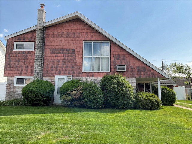 2492 2nd St, East Meadow, NY 11554 - view of home's exterior with a chimney and a yard