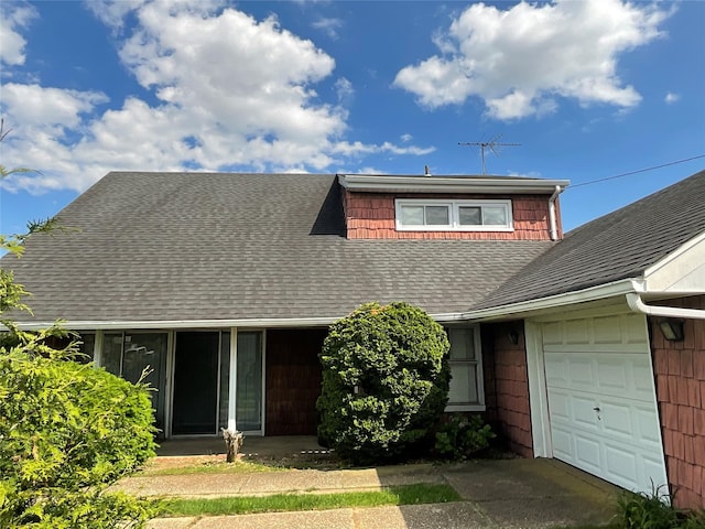 2492 2nd St, East Meadow, NY 11554 - view of front of home featuring a garage and a shingled roof