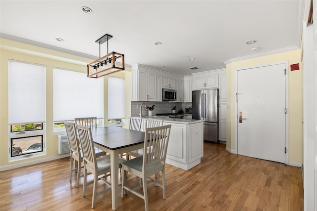260 W Broadway Unit 2G, Long Beach, NY 11561 - dining room featuring light wood-style flooring, recessed lighting, baseboards, and crown molding
